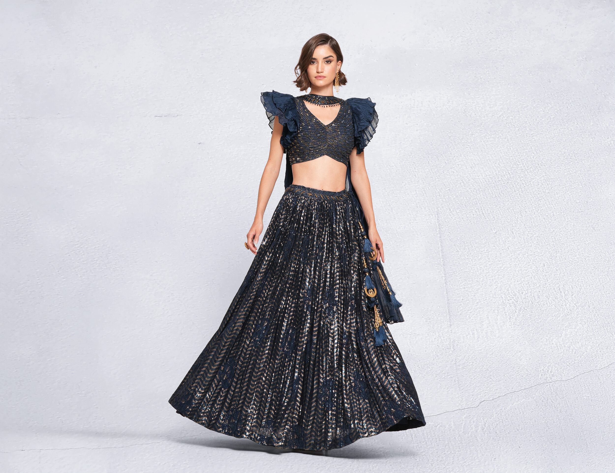 A beautiful woman in a glitter net lehenga
